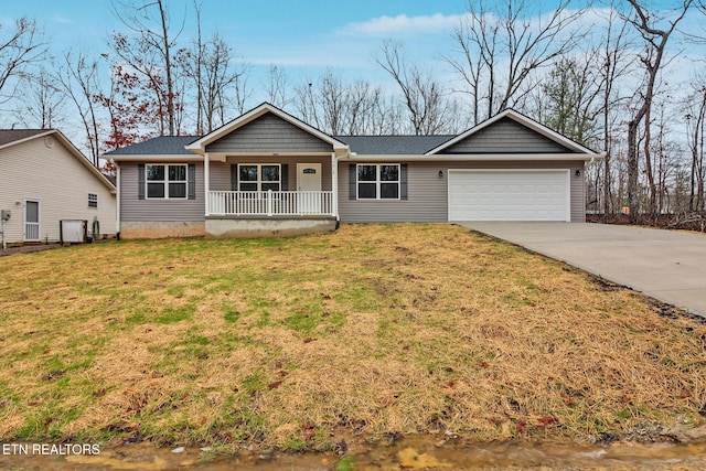 ranch-style house featuring a garage, a front yard, and covered porch