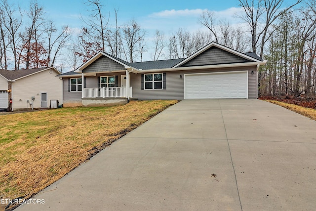 single story home with a garage, a front yard, and covered porch