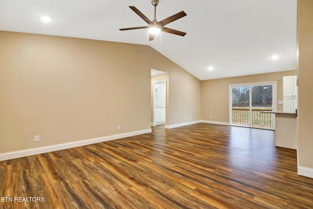 unfurnished room with ceiling fan, lofted ceiling, and dark hardwood / wood-style flooring