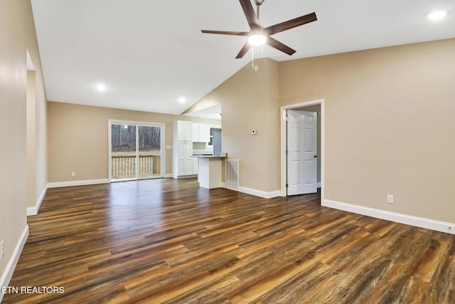 unfurnished living room featuring vaulted ceiling, dark hardwood / wood-style floors, and ceiling fan