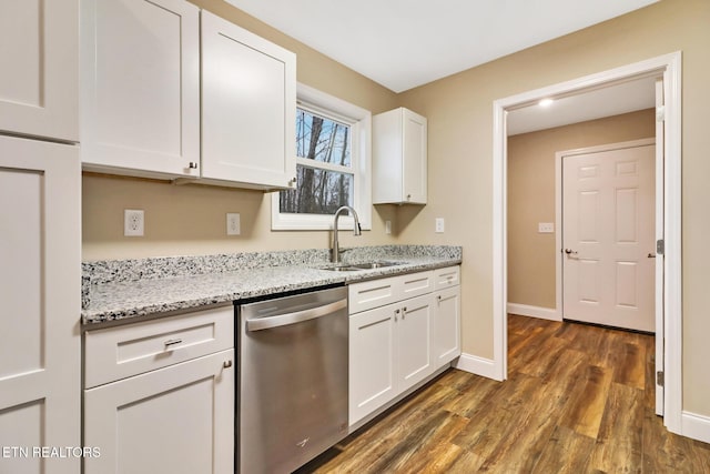 kitchen with sink, dark wood-type flooring, dishwasher, white cabinetry, and light stone counters