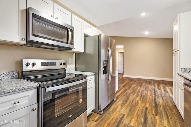 kitchen featuring white cabinetry, appliances with stainless steel finishes, dark wood-type flooring, and light stone counters