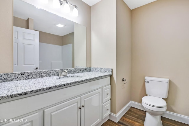 bathroom featuring vanity, toilet, and hardwood / wood-style floors