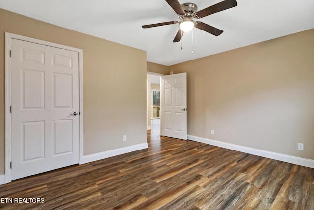 unfurnished bedroom with dark hardwood / wood-style flooring and ceiling fan