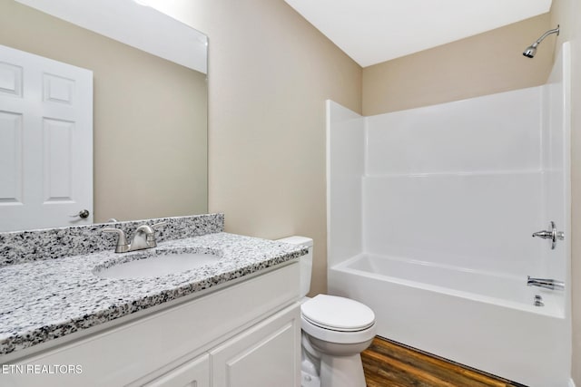 full bathroom featuring vanity, hardwood / wood-style floors, toilet, and shower / bath combination