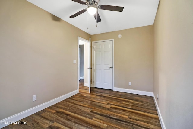 unfurnished bedroom with dark wood-type flooring and ceiling fan