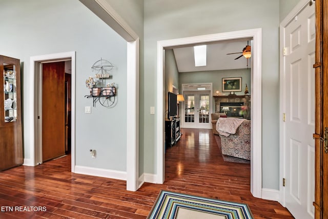 hallway with french doors, dark wood finished floors, and baseboards