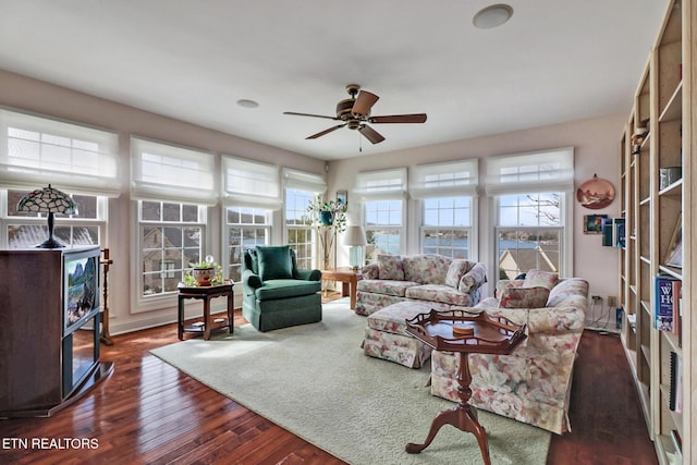 living room with dark wood-style flooring and a ceiling fan