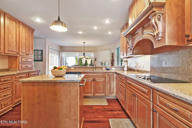 kitchen featuring light stone counters, decorative light fixtures, a peninsula, and black electric stovetop