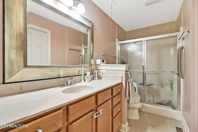 full bathroom with toilet, a stall shower, tile patterned floors, and vanity