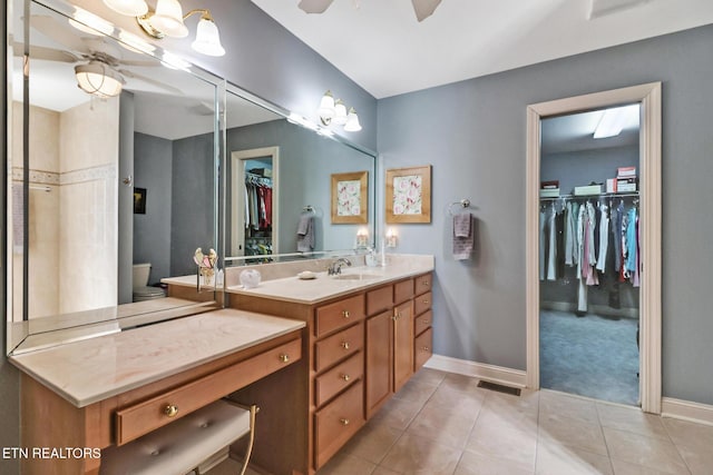 full bathroom featuring toilet, vanity, baseboards, a ceiling fan, and tile patterned floors