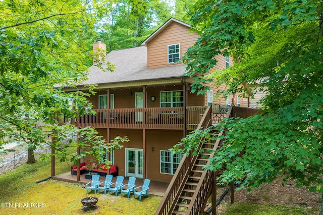 1447 Cove Pointe Rd, Lafollette, TN 37766 - back of house with a fire pit, stairway, a chimney, a shingled roof, and a balcony