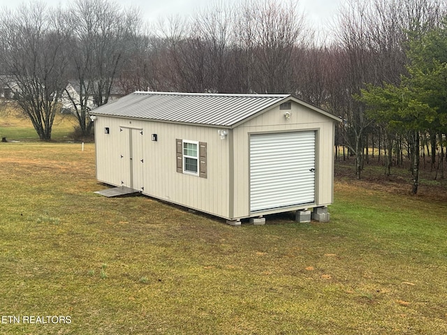 view of outbuilding with a yard