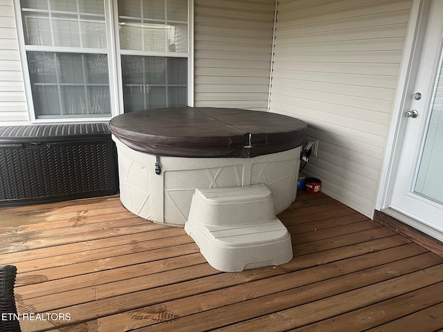 wooden deck featuring a hot tub