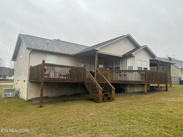 rear view of house with a wooden deck, central AC unit, and a lawn