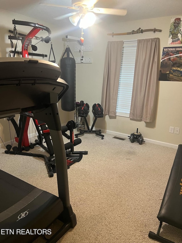 exercise room with carpet and ceiling fan