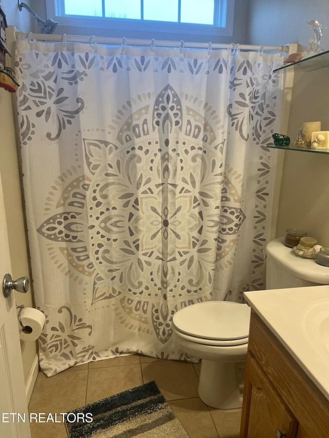 bathroom with tile patterned floors, toilet, vanity, and plenty of natural light