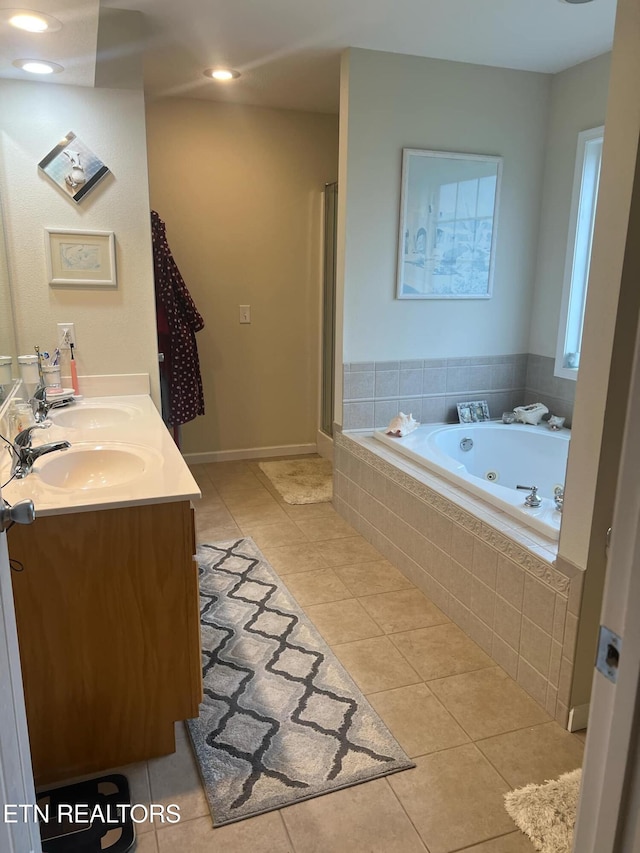 bathroom with tile patterned flooring, vanity, and shower with separate bathtub