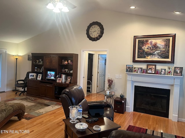 living room featuring lofted ceiling and light hardwood / wood-style flooring