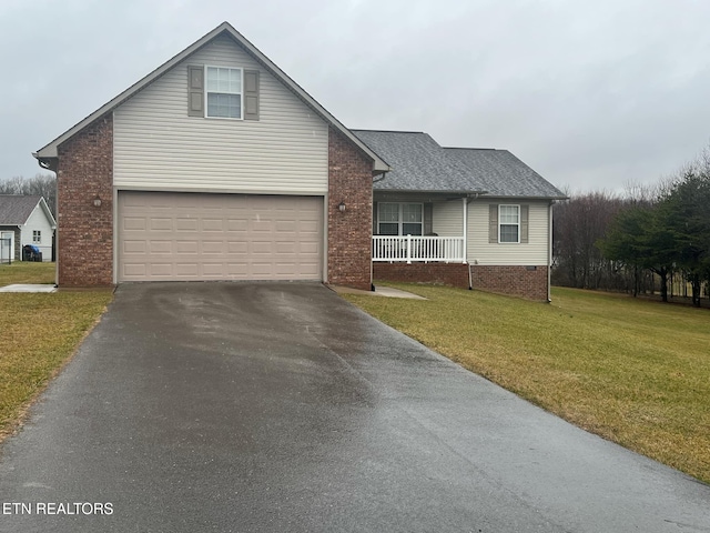 view of front of property featuring a porch, a garage, and a front lawn