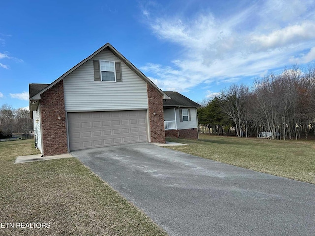 traditional home with an attached garage, aphalt driveway, a front lawn, and brick siding