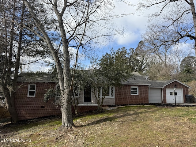 single story home with a garage and a front yard