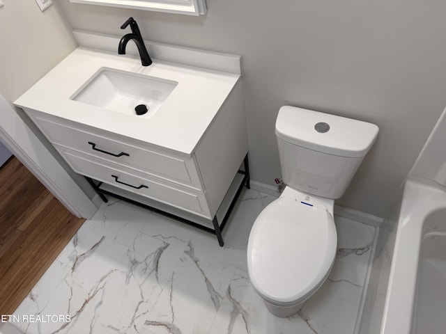 bathroom featuring vanity and toilet