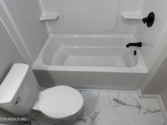 bathroom with a tub and toilet