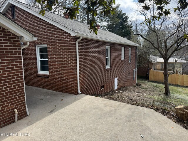 view of side of home with a patio
