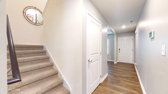 stairs with hardwood / wood-style floors