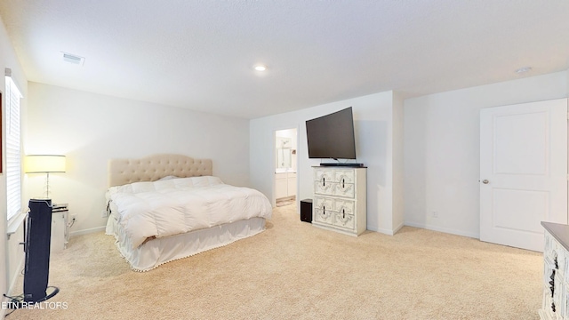 carpeted bedroom featuring ensuite bath