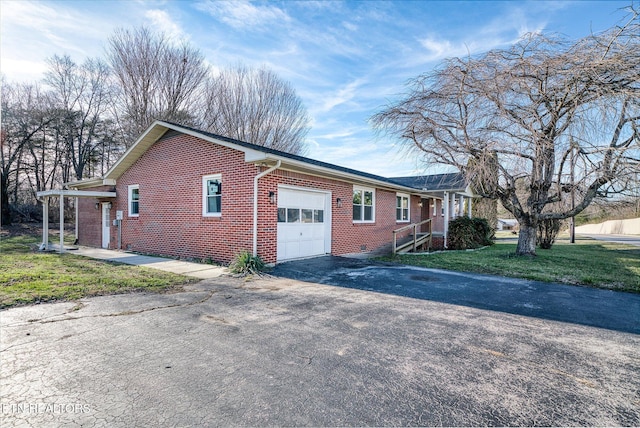 view of side of property with a yard and a garage