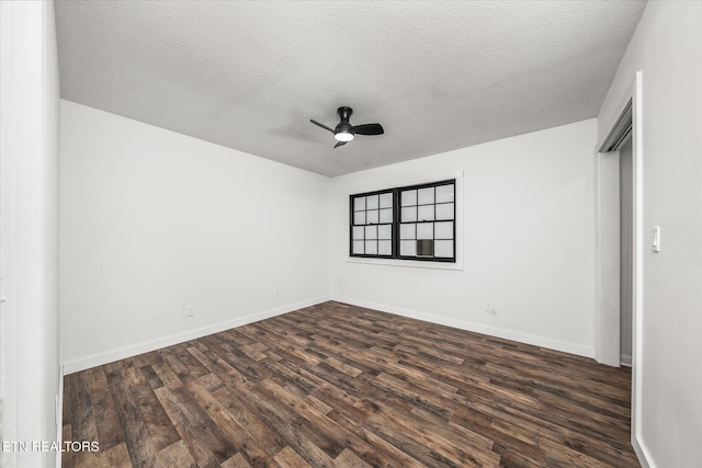 unfurnished room with ceiling fan, dark hardwood / wood-style floors, and a textured ceiling