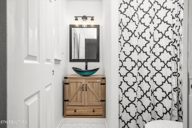 bathroom featuring vanity and a shower with shower curtain