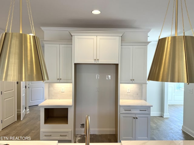 kitchen featuring decorative backsplash, baseboards, ornamental molding, and light wood finished floors