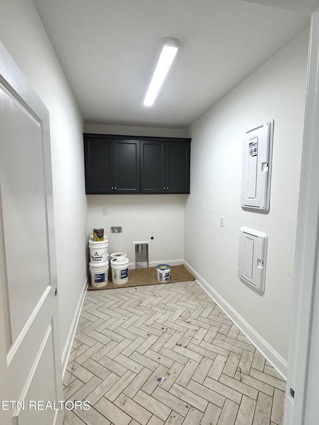 laundry area featuring electric panel, baseboards, cabinet space, and hookup for a washing machine