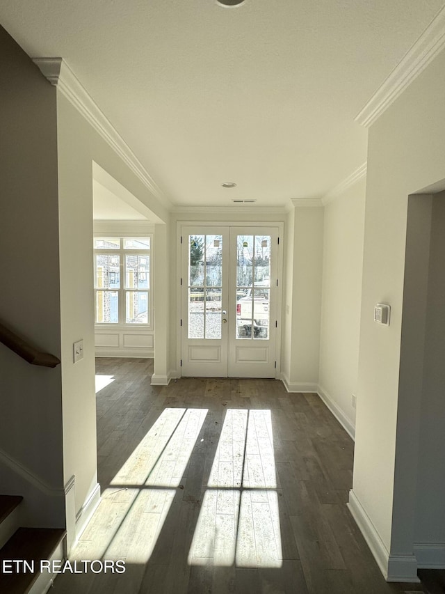 interior space featuring ornamental molding, hardwood / wood-style floors, french doors, baseboards, and stairs