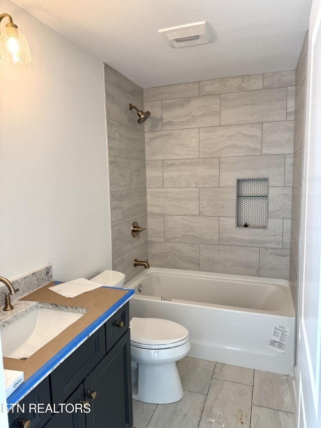 full bathroom with vanity, visible vents, shower / washtub combination, a textured ceiling, and toilet