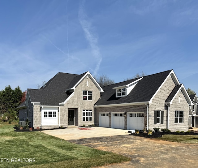 11707 Grigsby Chapel Rd, Knoxville, TN 37934 - view of front facade with brick siding, concrete driveway, a front lawn, a garage, and a shingled roof