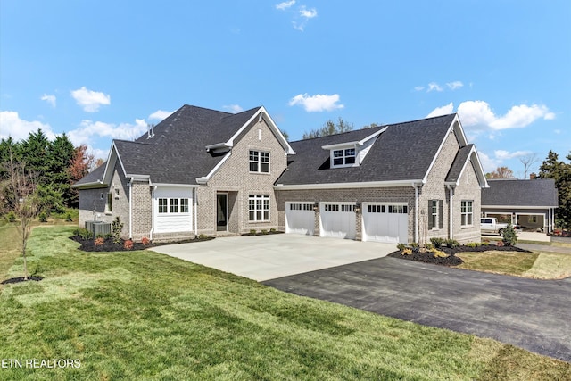 11707 Grigsby Chapel Rd, Knoxville, TN 37934 - view of front of home featuring brick siding, asphalt driveway, central AC unit, a garage, and a front yard