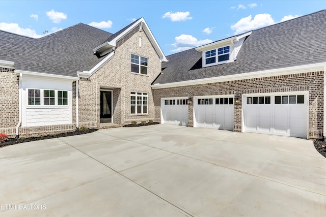 11707 Grigsby Chapel Rd, Knoxville, TN 37934 - view of front facade with brick siding, concrete driveway, an attached garage, and roof with shingles