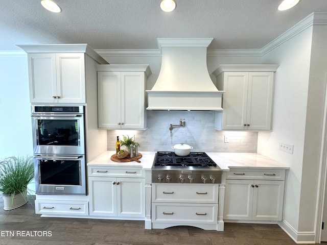 11707 Grigsby Chapel Rd, Knoxville, TN 37934 - kitchen with stainless steel appliances, wall chimney range hood, dark wood-style floors, decorative backsplash, and crown molding