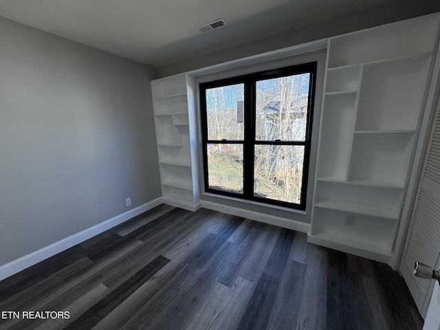 empty room featuring dark wood-type flooring