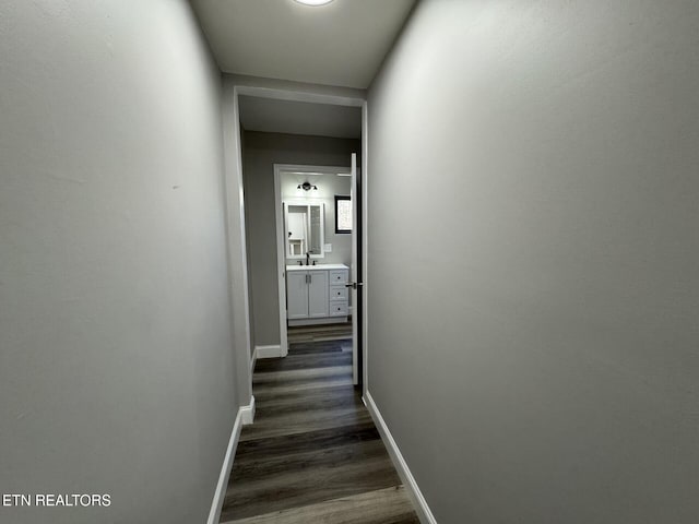 hallway with dark hardwood / wood-style floors and sink