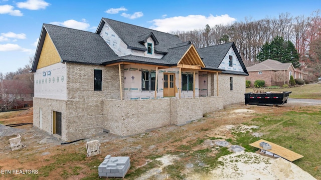 property under construction featuring brick siding and roof with shingles