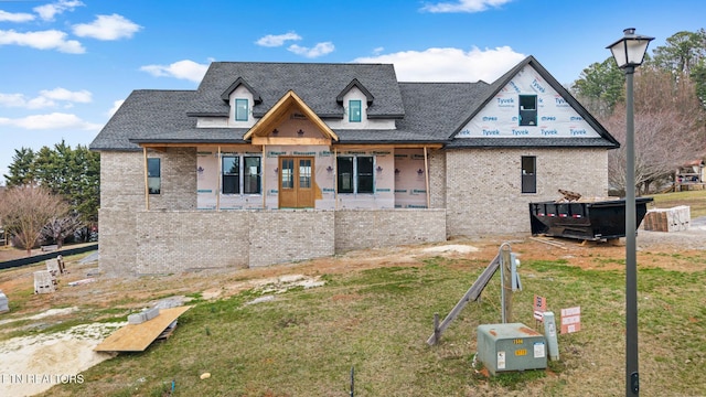 view of front of home with brick siding and a front lawn