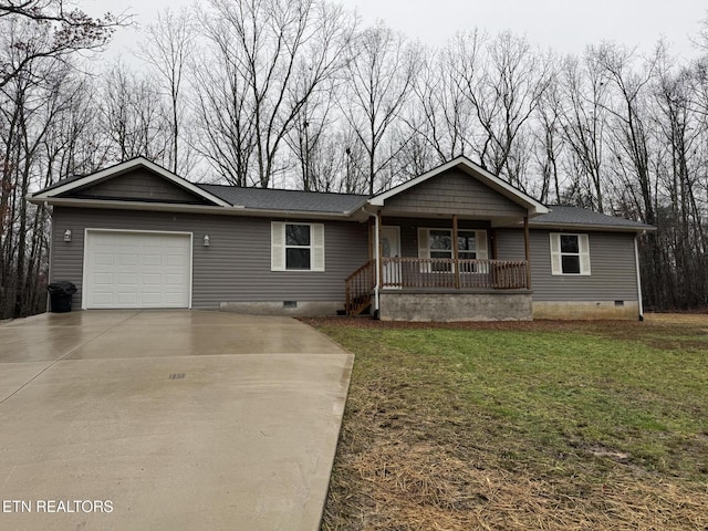 view of front of property featuring a garage, a front lawn, and a porch