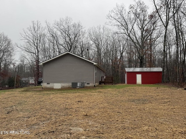 view of home's exterior featuring an outbuilding and a yard