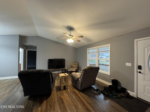 living room with lofted ceiling, dark wood-type flooring, and ceiling fan