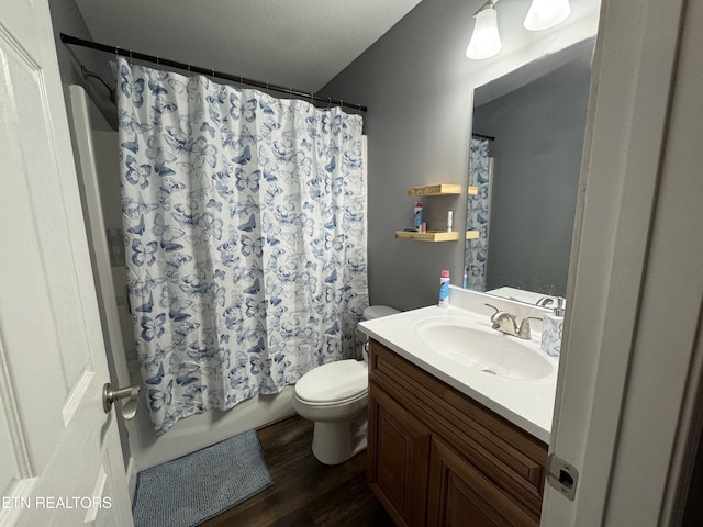 full bathroom with vanity, wood-type flooring, shower / bath combo, and toilet